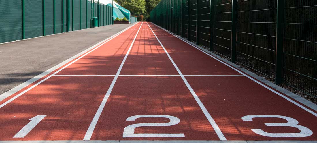 Outdoor running track with numbered lanes